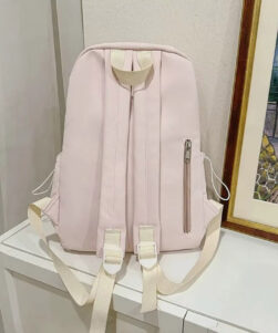 Back view of pink cat backpack with ears showing padded shoulder straps and structured canvas construction