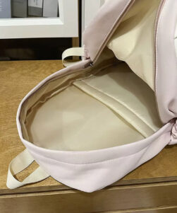 Interior of pink cat backpack with ears showing main canvas compartment and polyester lining