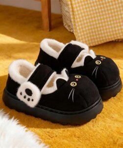 Cat slippers for women, pair on yellow rug, angled